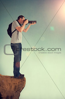 photographer on cliff ledge