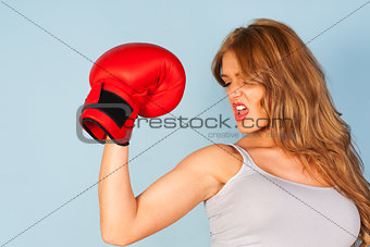 woman in vest wearing red boxing gloves