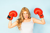 woman in vest wearing red boxing gloves