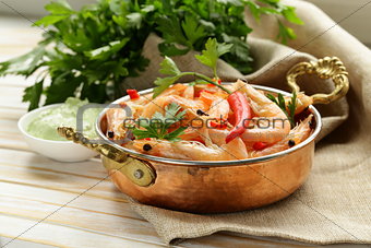 fried prawns with chilli in a copper pan, Indian style