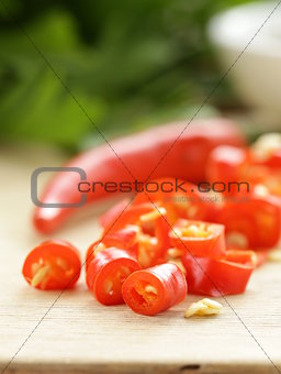 fresh red chili peppers on a wooden board