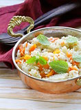 rice with vegetables cooked in Indian style in a copper pan