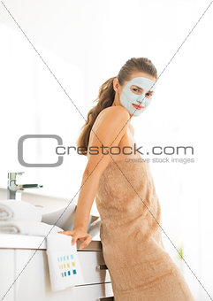 Portrait of young woman wearing facial cosmetic mask