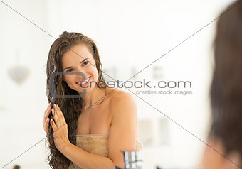 Portrait of happy young woman with wet hairs in bathroom