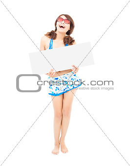 young girl wearing a swimwear  and holding a white board
