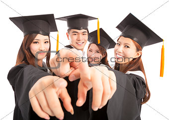 happy group graduate students point to the same direction