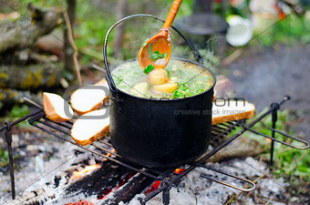 The cooking of soup on the fire