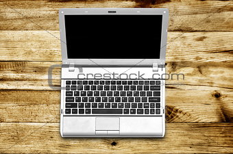 Laptop on wood background