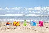 Brightly colored plastic beach toys on the beach