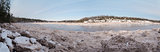 Panorama of forest river covered with snow and ice 