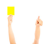 Hand of referee with yellow card to warn