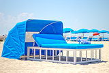 Luxurious beach bed with canopy on a sandy beach