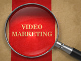 Video Marketing Concept Through Magnifying Glass.