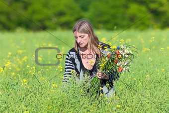 Woman Picking Wild Flowers on the Meadow 