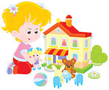 Girl with a doll and toy house