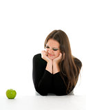 girl with grimace on her face and green apple