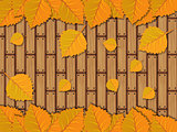 Autumn leaves over wooden planks