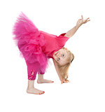 little girl in a pink dress dancing in the studio bow