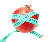 Measure tape on red pomegranate