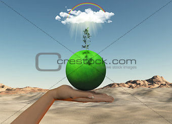 Female hand holding grassy globe with seedling