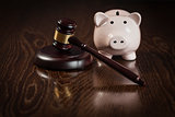 Gavel and Piggy Bank on Table