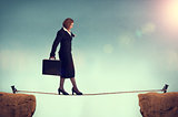 businesswoman balancing on a tightrope 