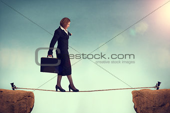 businesswoman balancing on a tightrope 