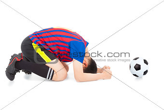 soccer player lose the game and kneel down