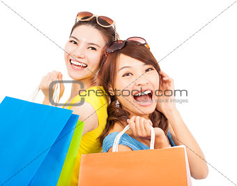 happy young women with shopping bags