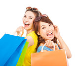 happy young sisters with shopping bags