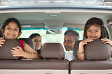 Indian family sitting in car 