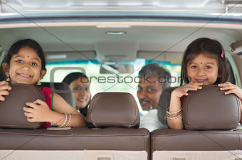 Indian family sitting in car 