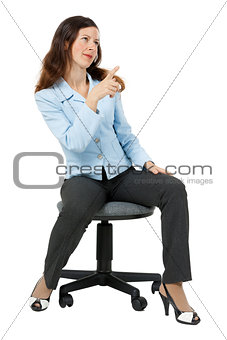 woman points at something sitting on an office chair