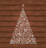 Christmas pine made of snowflakes on wooden background
