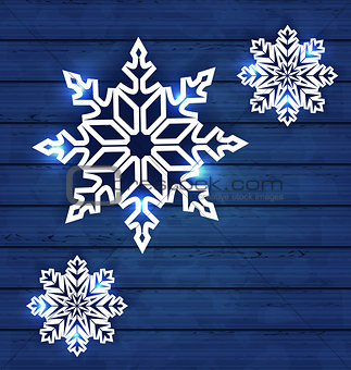 Set snowflakes on wooden background
