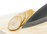  Sausage with knife over cutting board