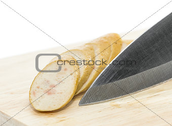  Sausage with knife over cutting board