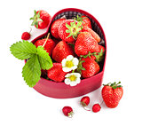 fresh strawberries in box as heart with green leaf