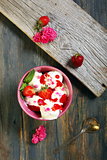 Ice cream with strawberries and rose petals.