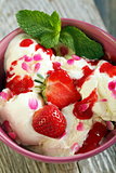 Ice cream with strawberries and rose petals.