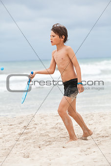 happy little child kid boy  playing beachball on beach in summer 