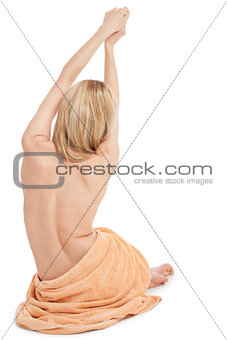 young blonde woman sitting on towel naked back isolated 