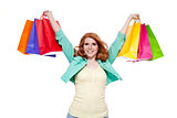 smiling young redhead girl with colorful shoppingbags 