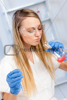 young woman doing experiment in laboratory