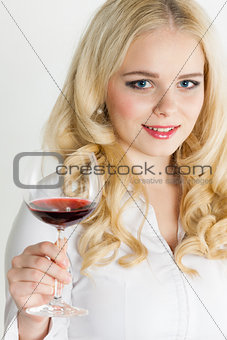portrait of young woman with a glass of red wine