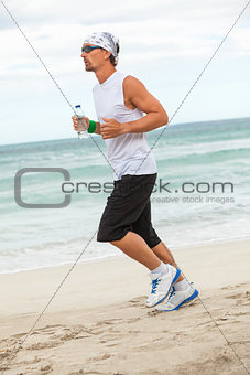 man is jogging on the beach summertime sport fitness