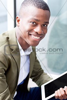 smiling successful businessman with tablet pc outdoor