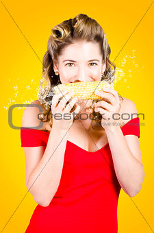 Retro pinup girl eating GMO free corn cob