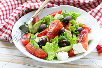 Mediterranean salad with black olives, lettuce, cheese and tomatoes