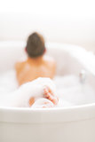 Closeup on young woman laying in bathtub